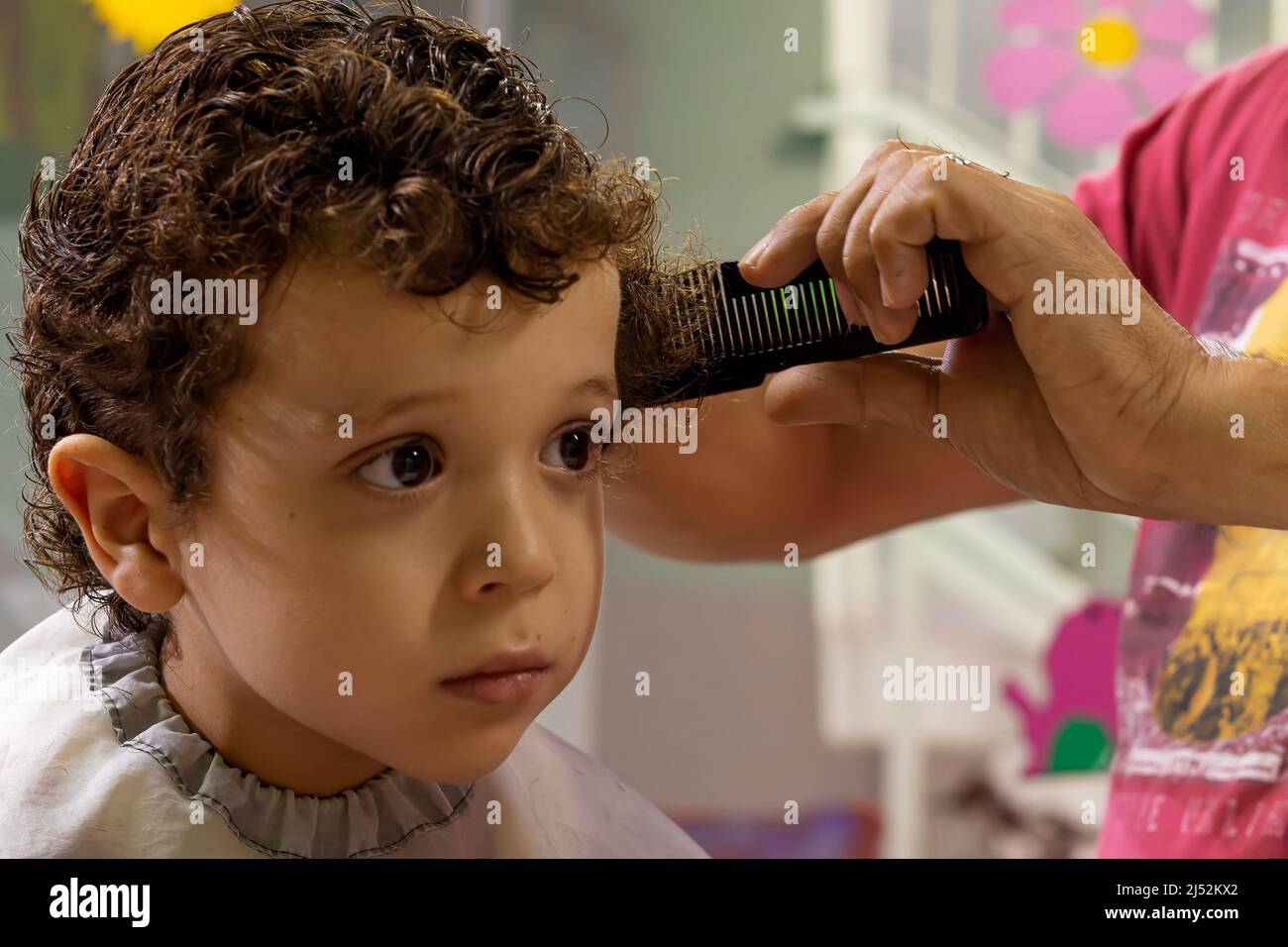 hairdresser cutting child's hair Stock Photo Alamy