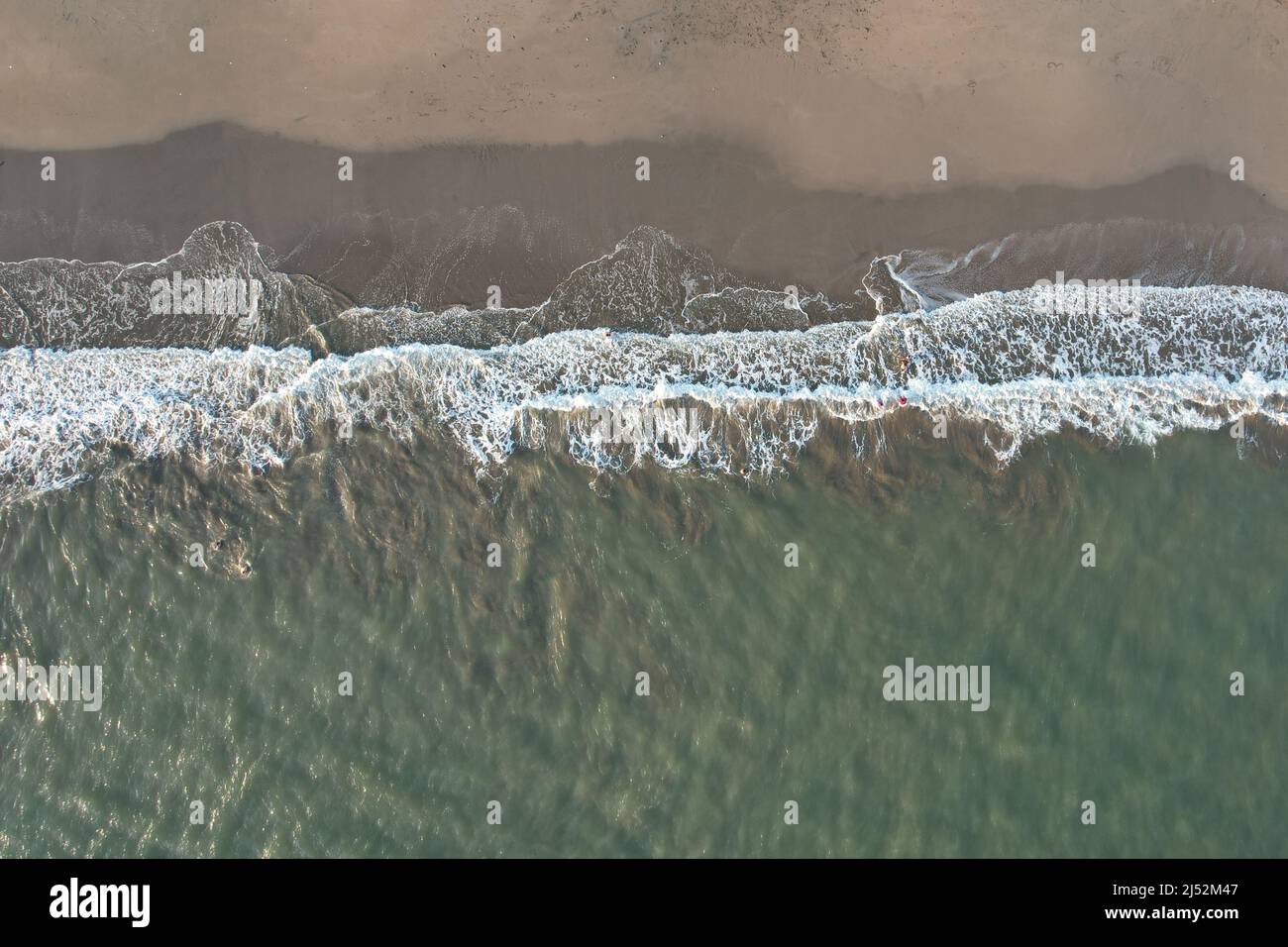 Clean empty beach with waves above drone top view Stock Photo