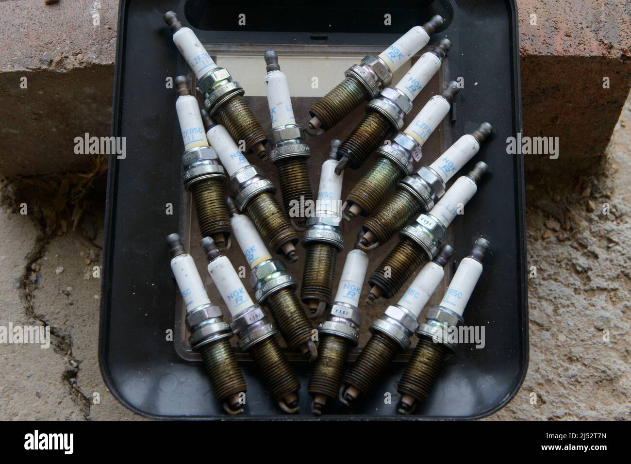 Old spark plugs taken out of a six cylinder engine after 100,000miles Stock Photo