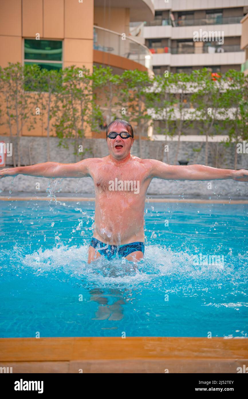 sporty man jumping in the big pool Stock Photo