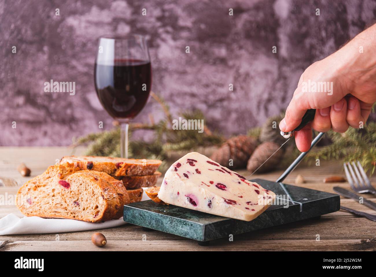 Wensleydale cheese with cranberries on a marble cheese cutting table. Stock Photo