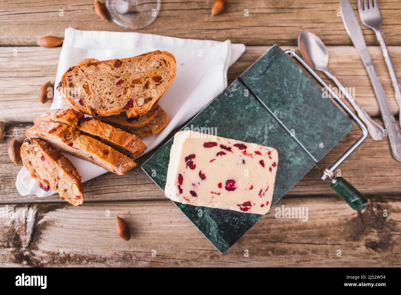 Wensleydale cheese with cranberries on a marble cheese cutting table. Stock Photo