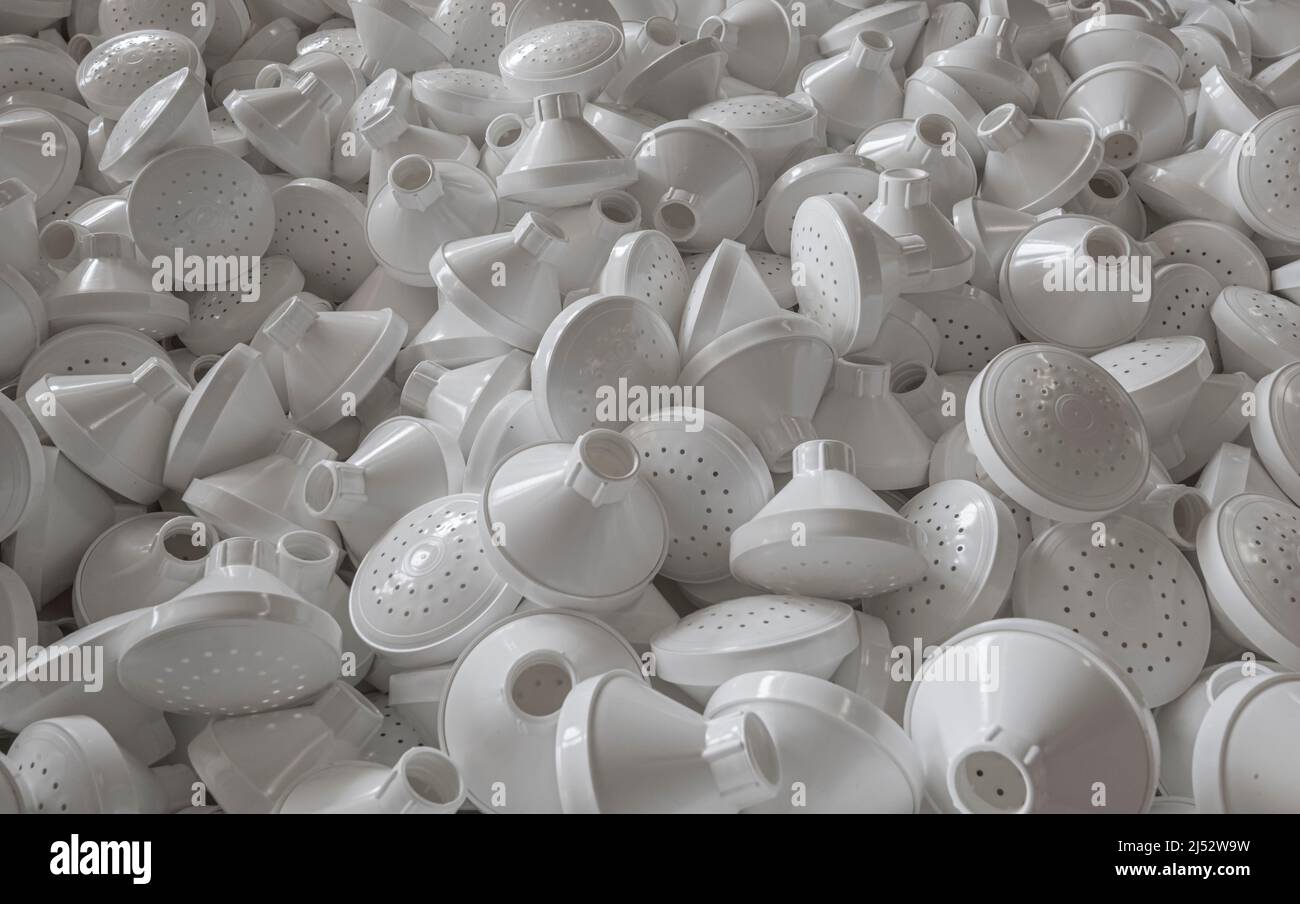 Large pile of plastic watering can pieces in manufacturing facility Stock Photo