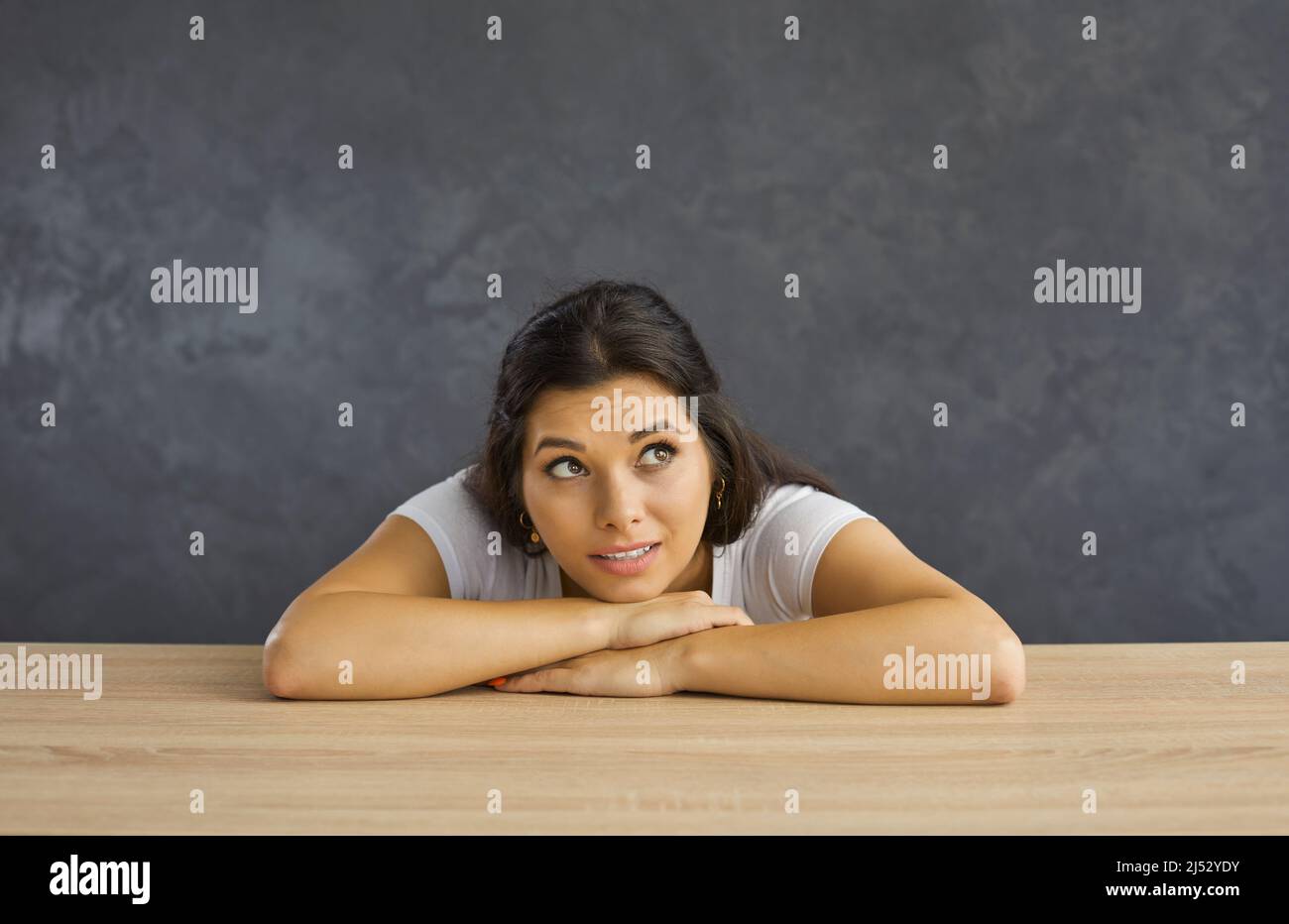 Young woman look up thinking of opportunities Stock Photo