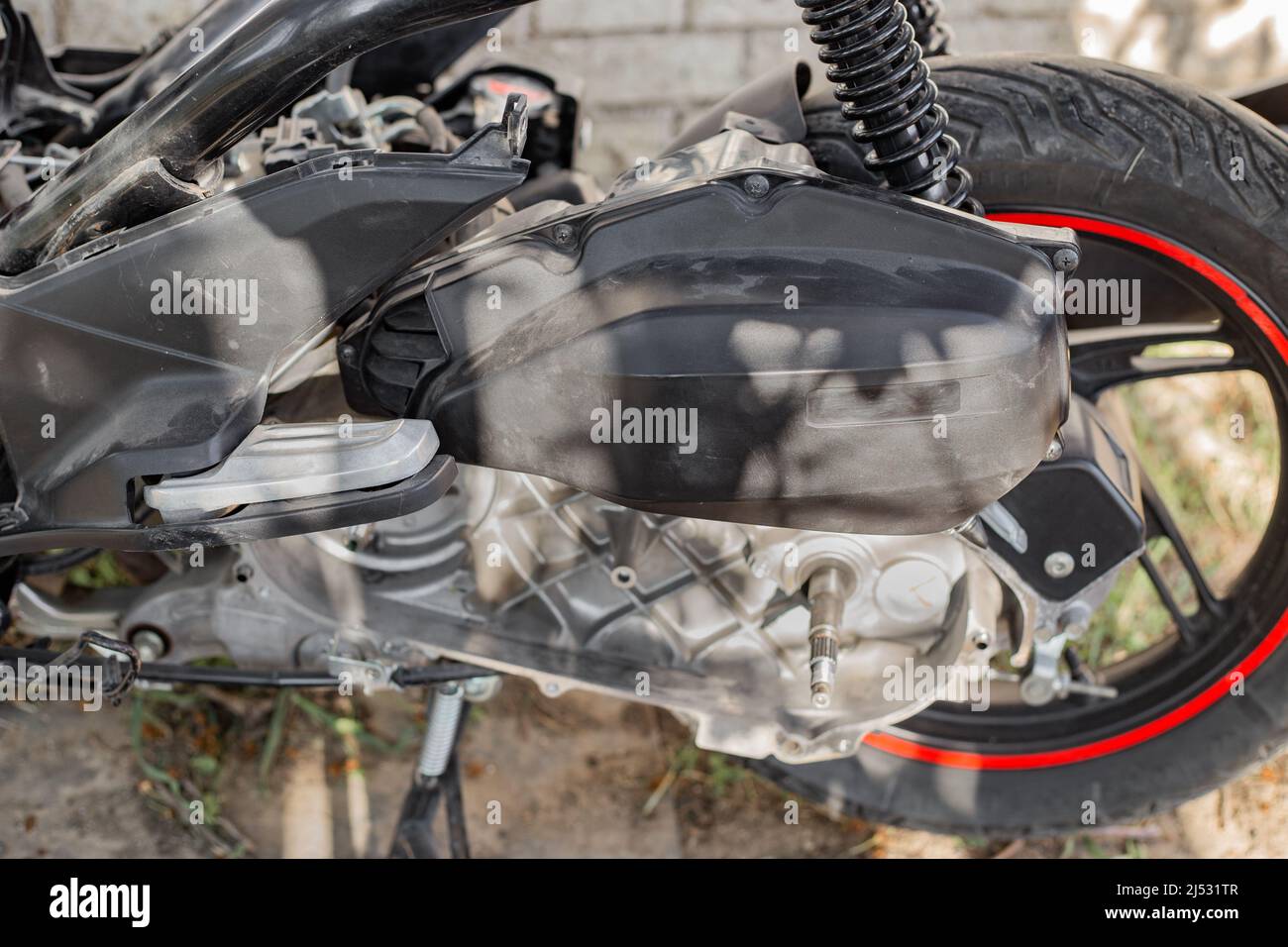 The back of the scooter with the variator housing and the rear wheel