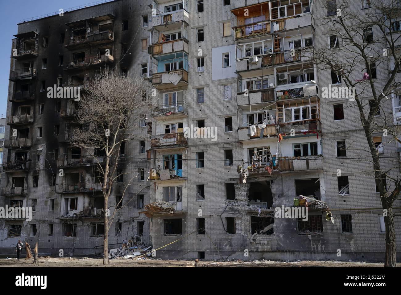 A destroyed residential building in the city that was damaged by a shell explosion during the war in Ukraine. House without windows. Stock Photo