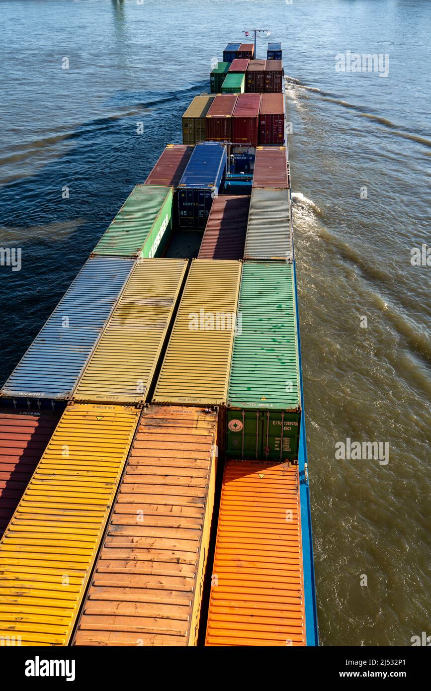 Container cargo ship on the Rhine, uphill to the south, the crane houses in Cologne at the Rheinauenhafen, Cologne South, residential and office build Stock Photo