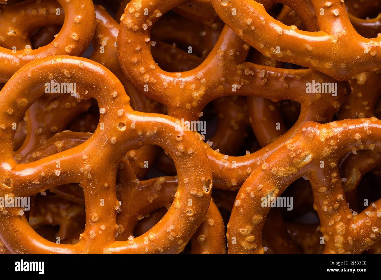 Large Snack Pretzels Pile Background Close Up. Stock Photo