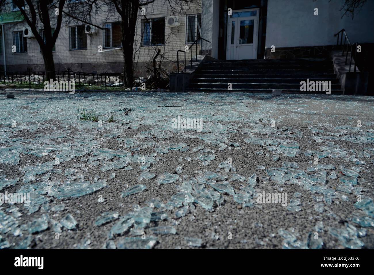 Pieces of broken glass lie on the pavement after the explosion Stock Photo