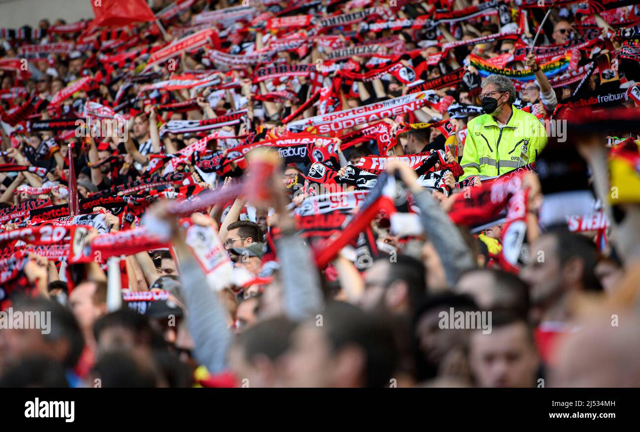 Fans of Ferencvarosi show their support as they hold scarves prior