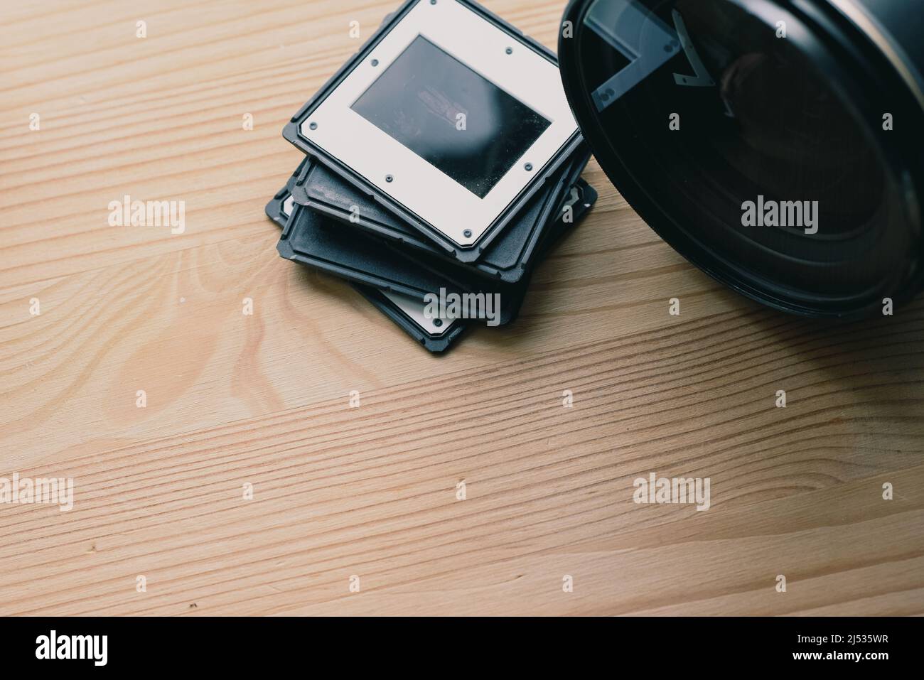 Camera lens and photographic slides for film projector Stock Photo Alamy