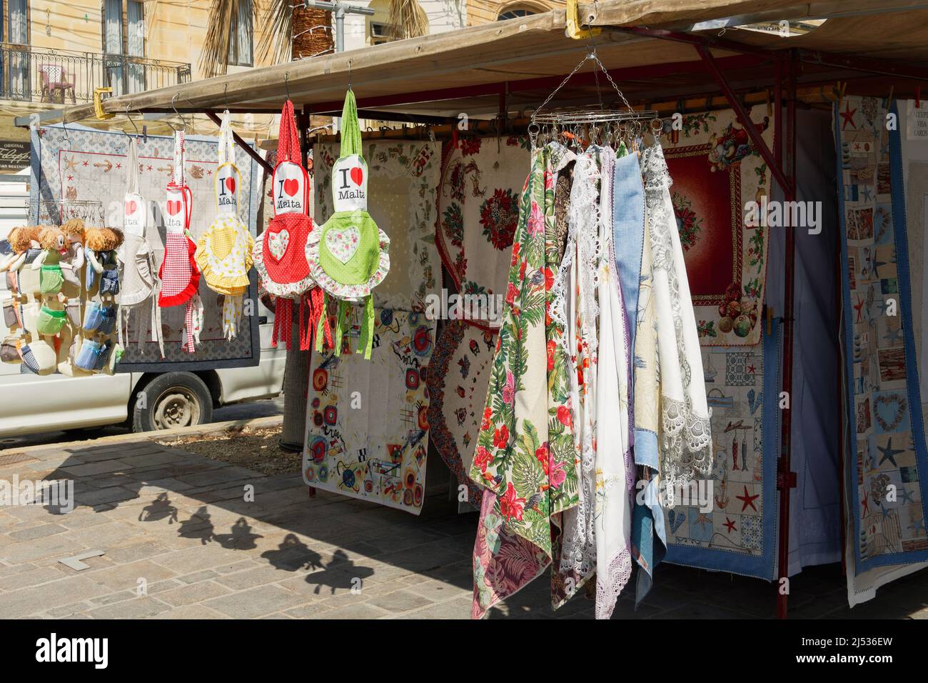 Open air street stalls market in Marsaxlokk village, with local gift