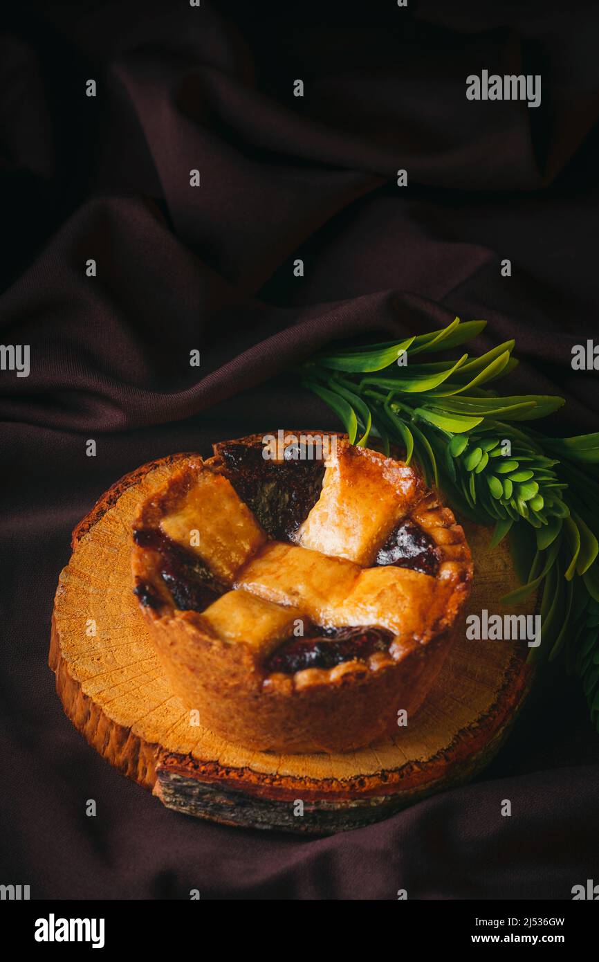 Homemade blackberry cake on a wooden surface with black background, gourmet bakery. Traditional Mexican sweet bread. Stock Photo