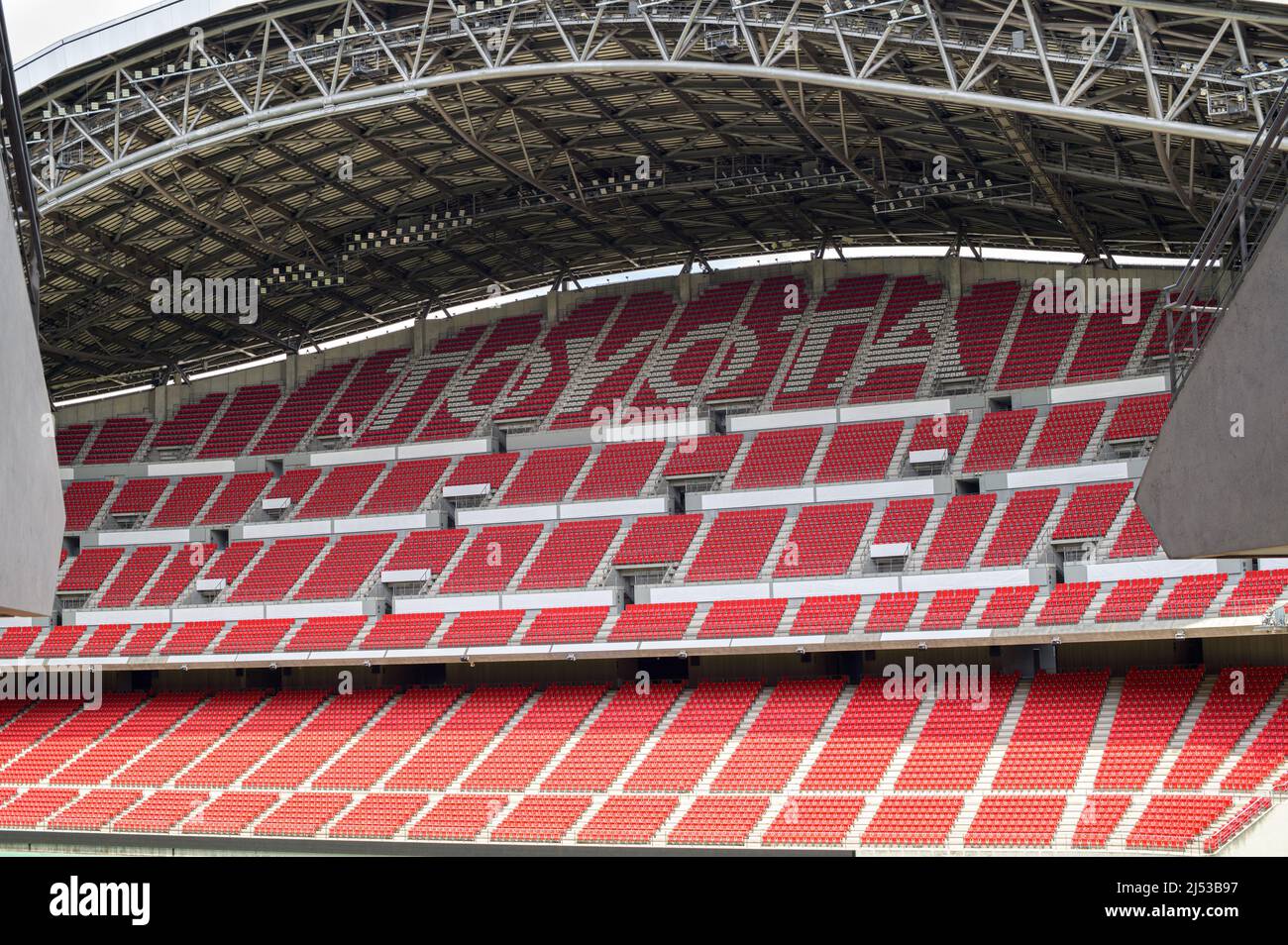 Rows of empty red plastic chairs at a Toyota sports stadium in Japan. Stock Photo