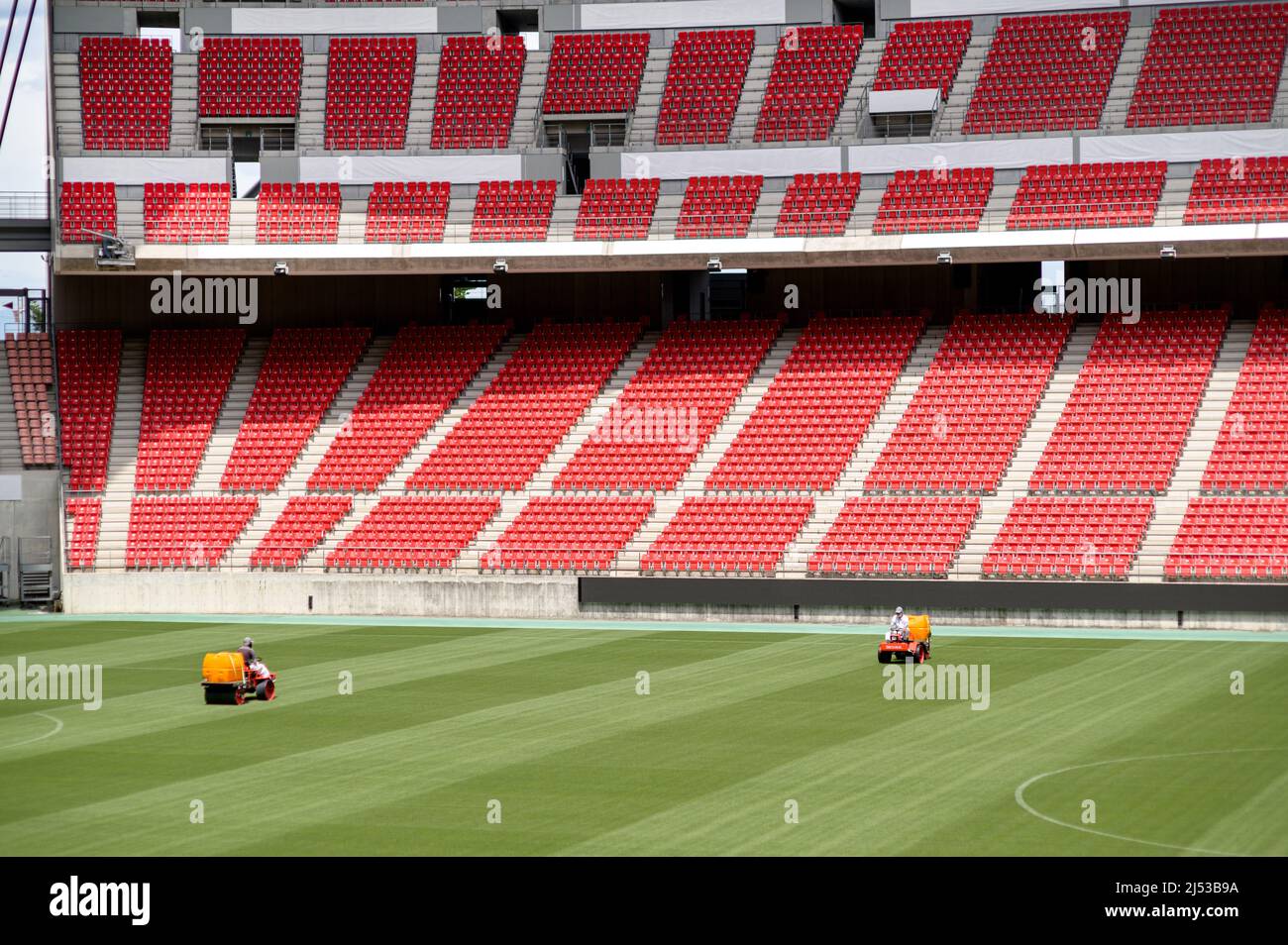 Lawn mowers working on the ground of the Toyota Stadium in Japan. Stock Photo