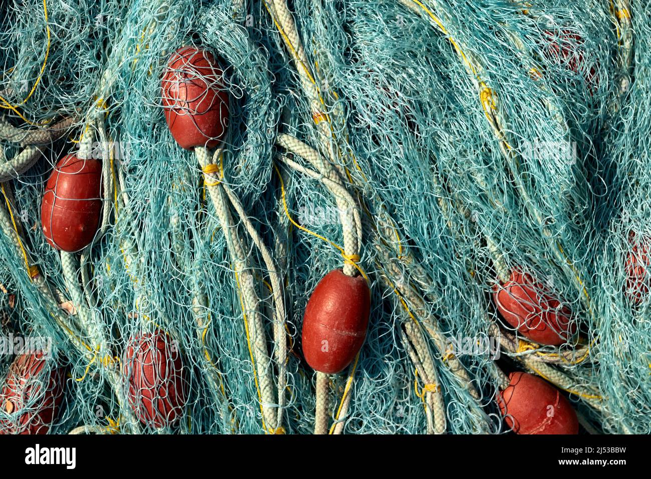 Blue fishing net with red buoys Stock Photo
