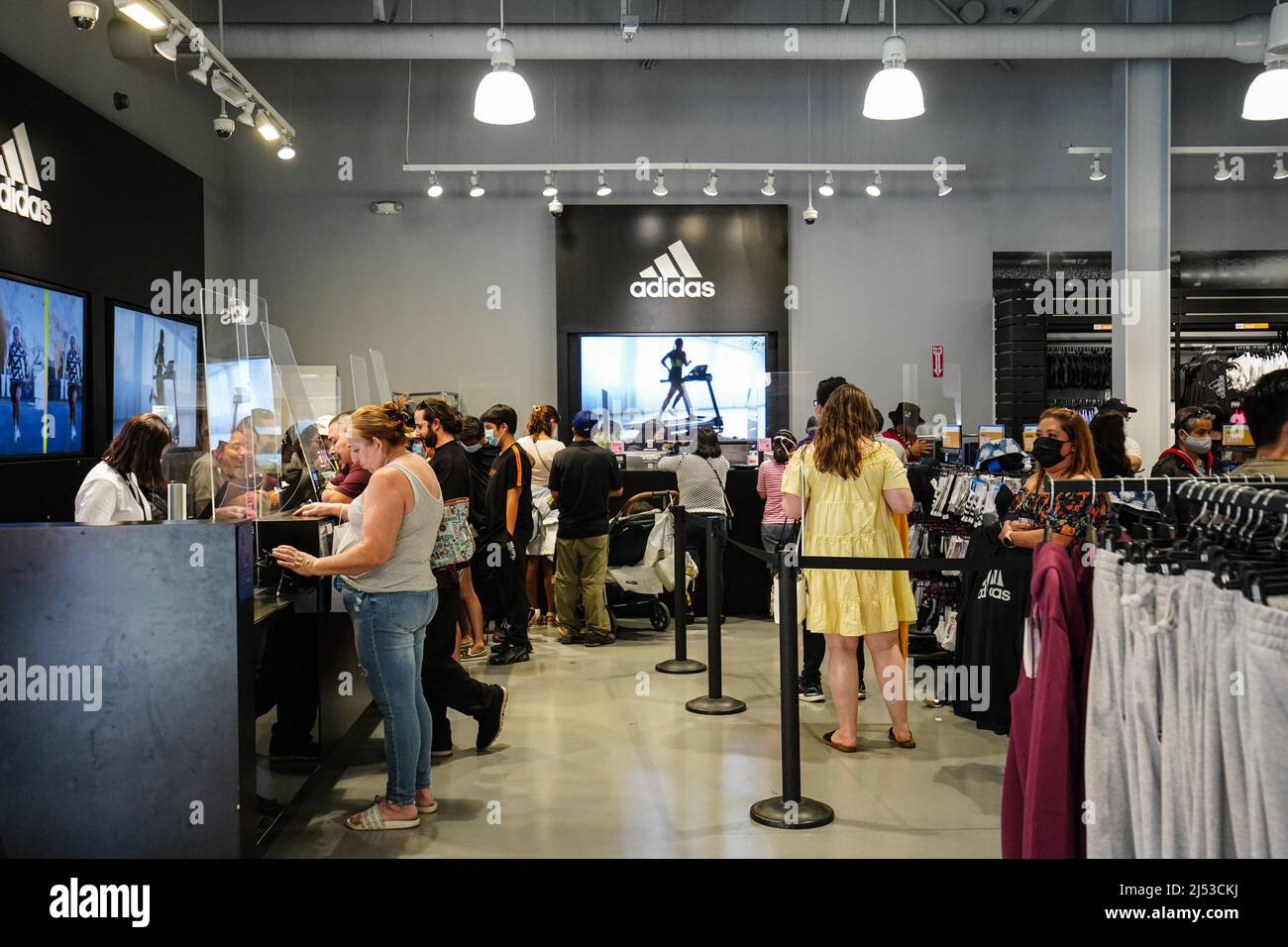 Orange, United States. 17th Apr, 2022. People seen inside an Adidas store at The Outlets in Orange. Many people at The Outlets in Orange, for clothes, shoes, watches, bags, and
