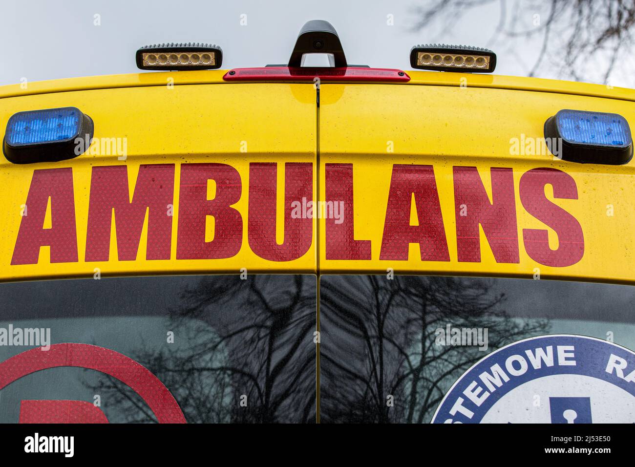 Red AMBULANCE lettering seen on the back of the new modern Mercedes-Benz Sprinter 4x4 ambulance service. Stock Photo