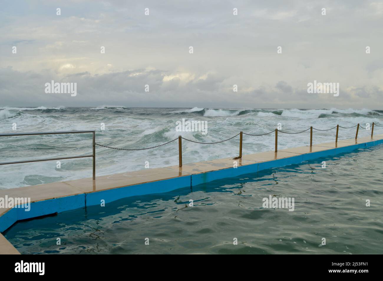 A strong surf breaks at South Curl Curl Beach in Sydney, Australia Stock Photo