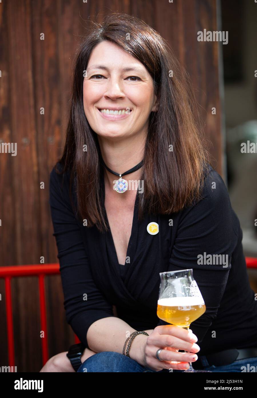 Bonn, Germany. 13th Apr, 2022. Beer sommelier Jutta Knoll holds a glass of beer in her hand. In