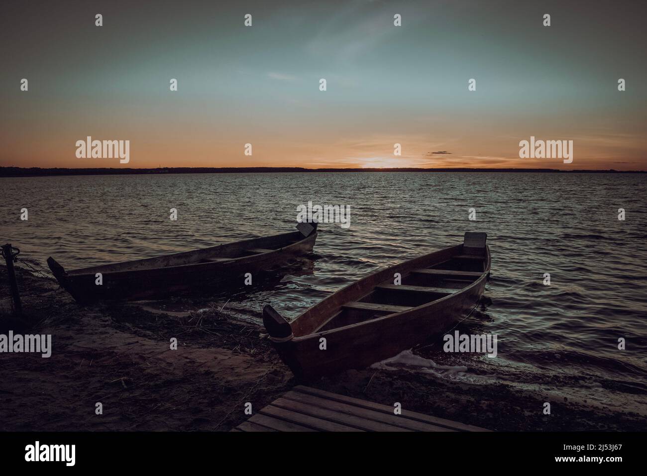 Two wooden boats are moored near the lake Stock Photo - Alamy