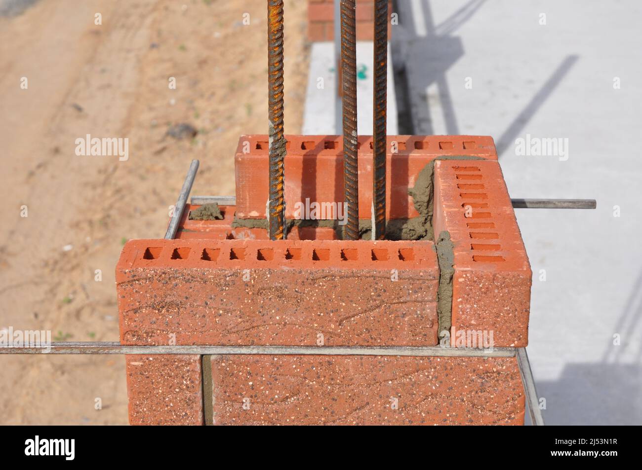 Bricklaying construction. Installing Red Clinker Blocks and Caulking