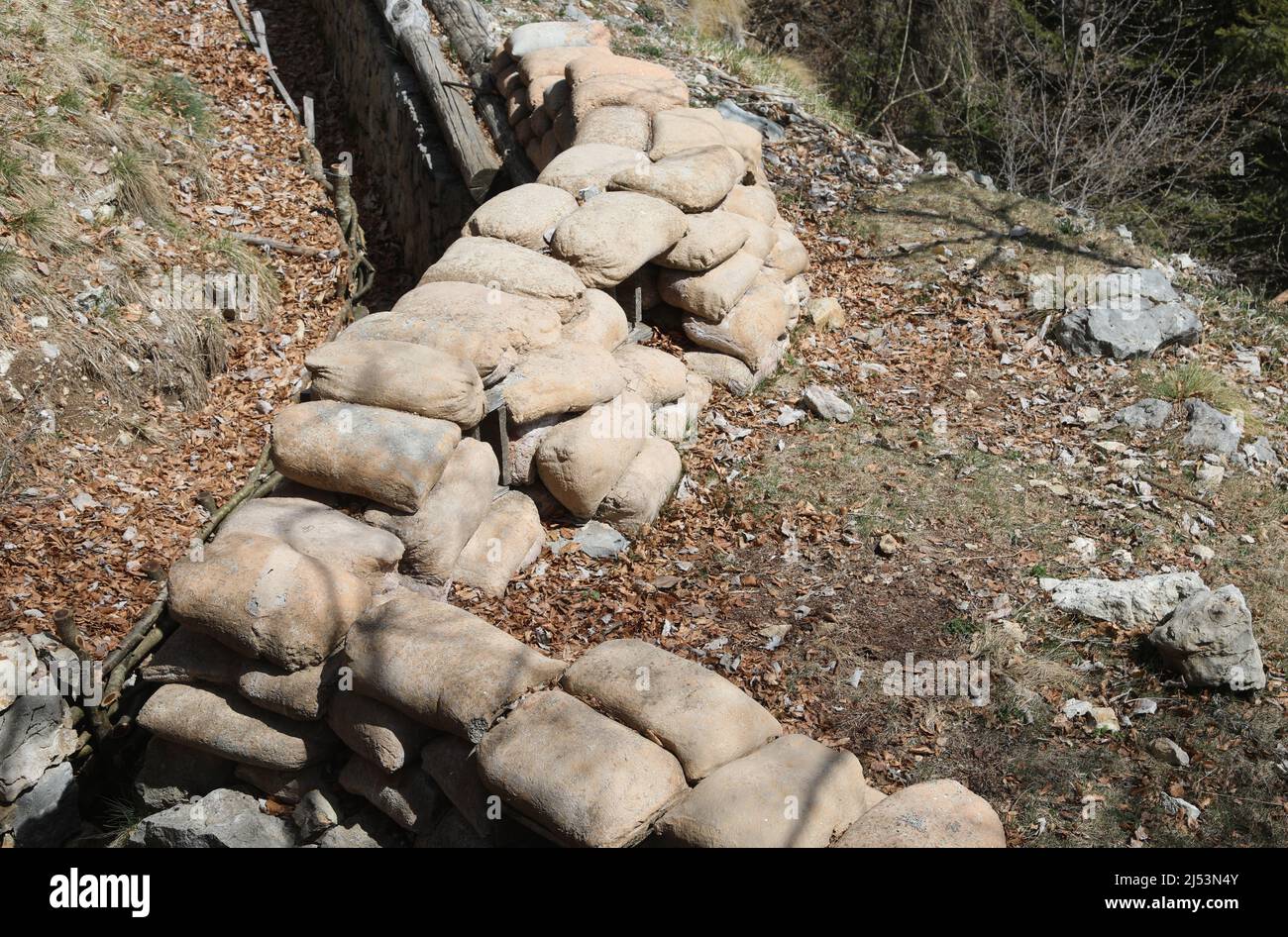 trench protection sandbags dug into the ground by army soldiers during war to defend Stock Photo