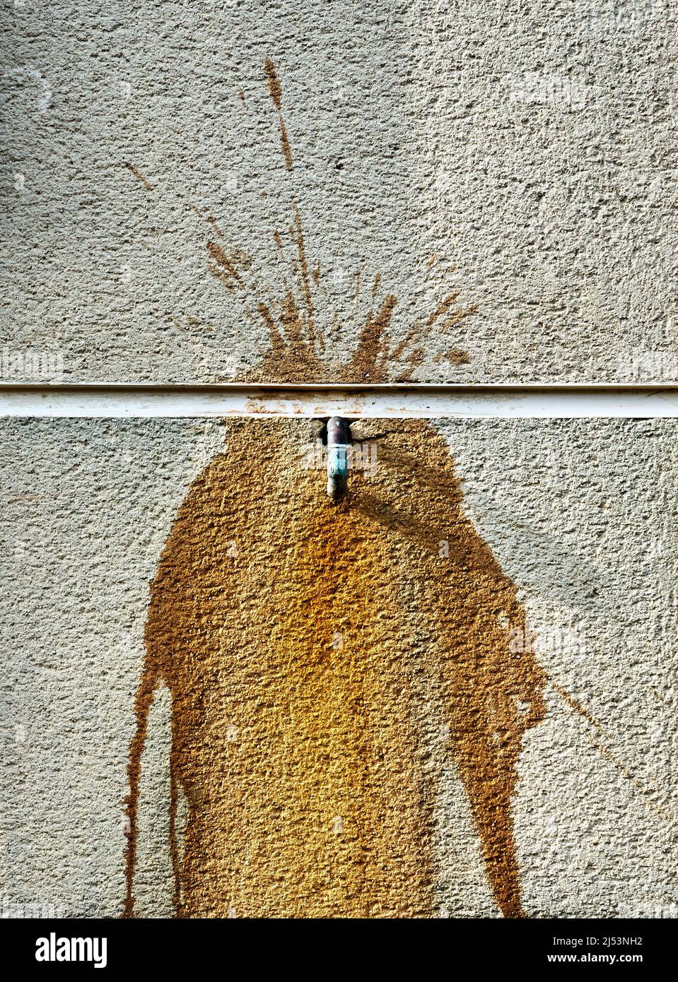 A copper pipe and rust on a concrete wall Stock Photo Alamy