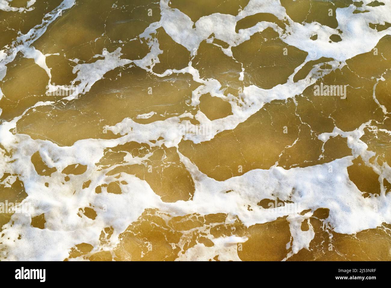Brown sea water abstract with white bubbles Stock Photo