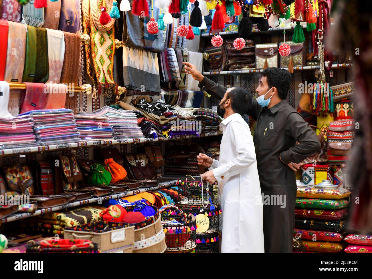 Doha, Qatar. 19th Apr, 2022. People buy traditional items at a shop in