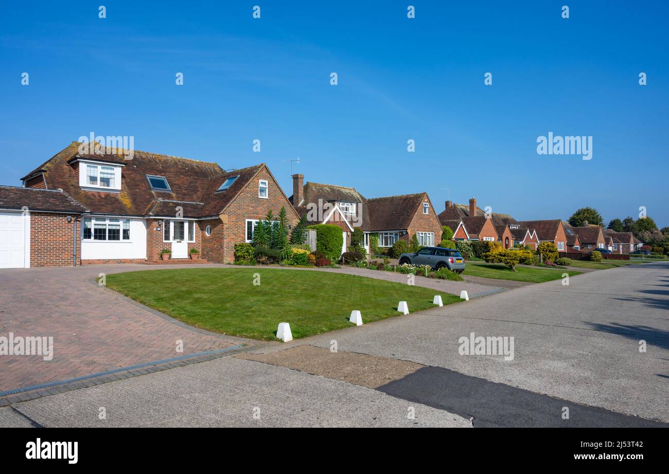 Row of detached houses on a private road with no pavements in Willowhayne Private Estate, East Preston, West Sussex, England, UK. Stock Photo