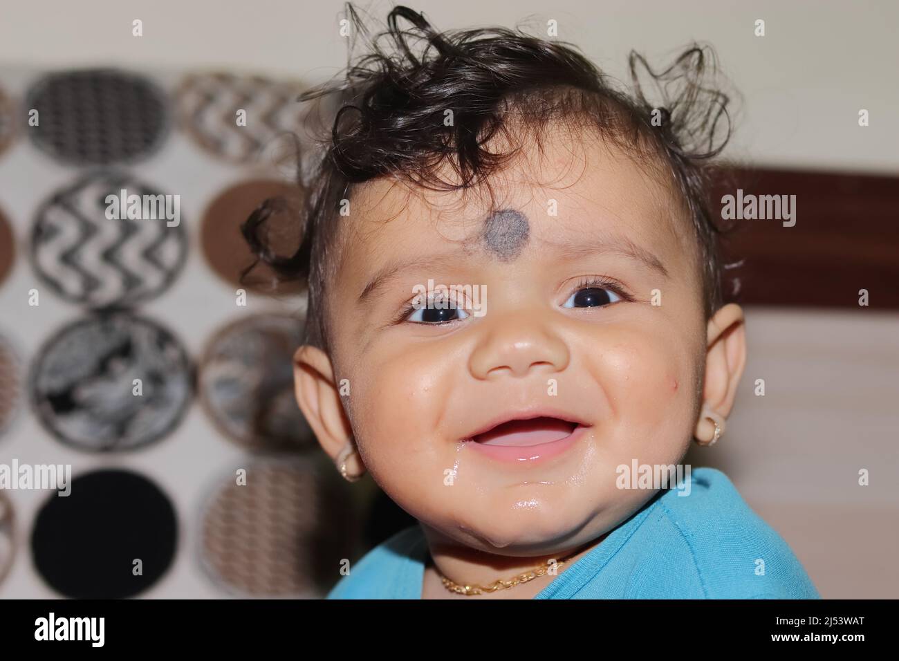 Close-up portrait photo of A lovely cute little Indian hindu baby boy looking at the camera with smiling face, india Stock Photo
