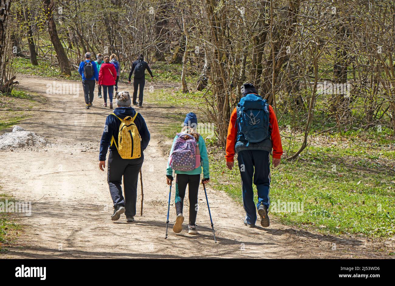 Young Group of people walking by hiking trail Stock Photo