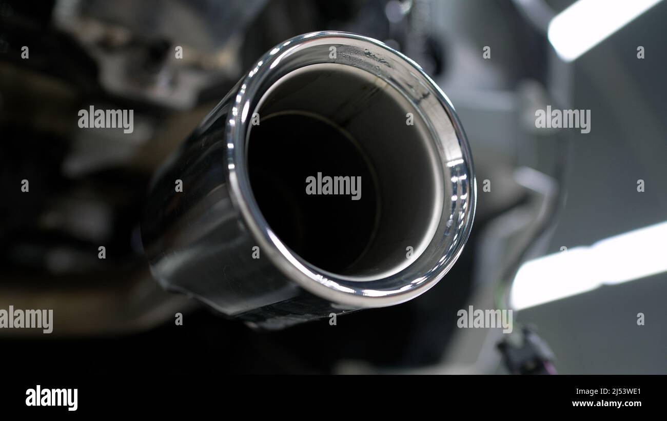 Powerful exhaust pipe from the car. Closeup of clean car muffler. New
