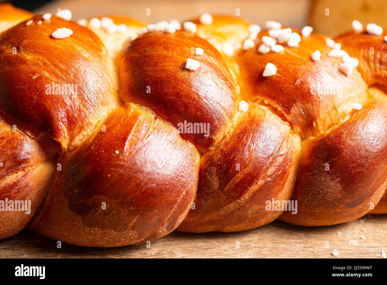 Beautiful three braid golden baked bread with egg wash and hail sugar. Challah is a special