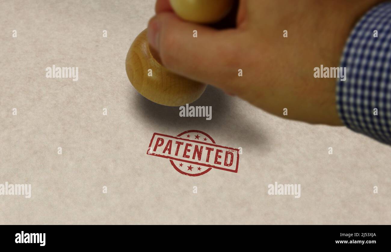 Patented stamp and stamping hand. Patent pending, reserved, copyright and protection of intellectual property concept. Stock Photo