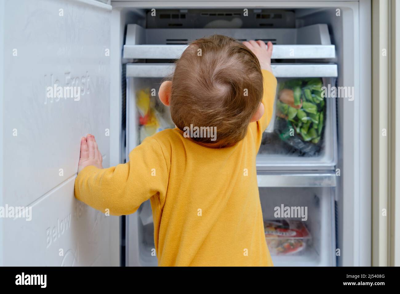 Boy looking in refrigerator hires stock photography and images Alamy