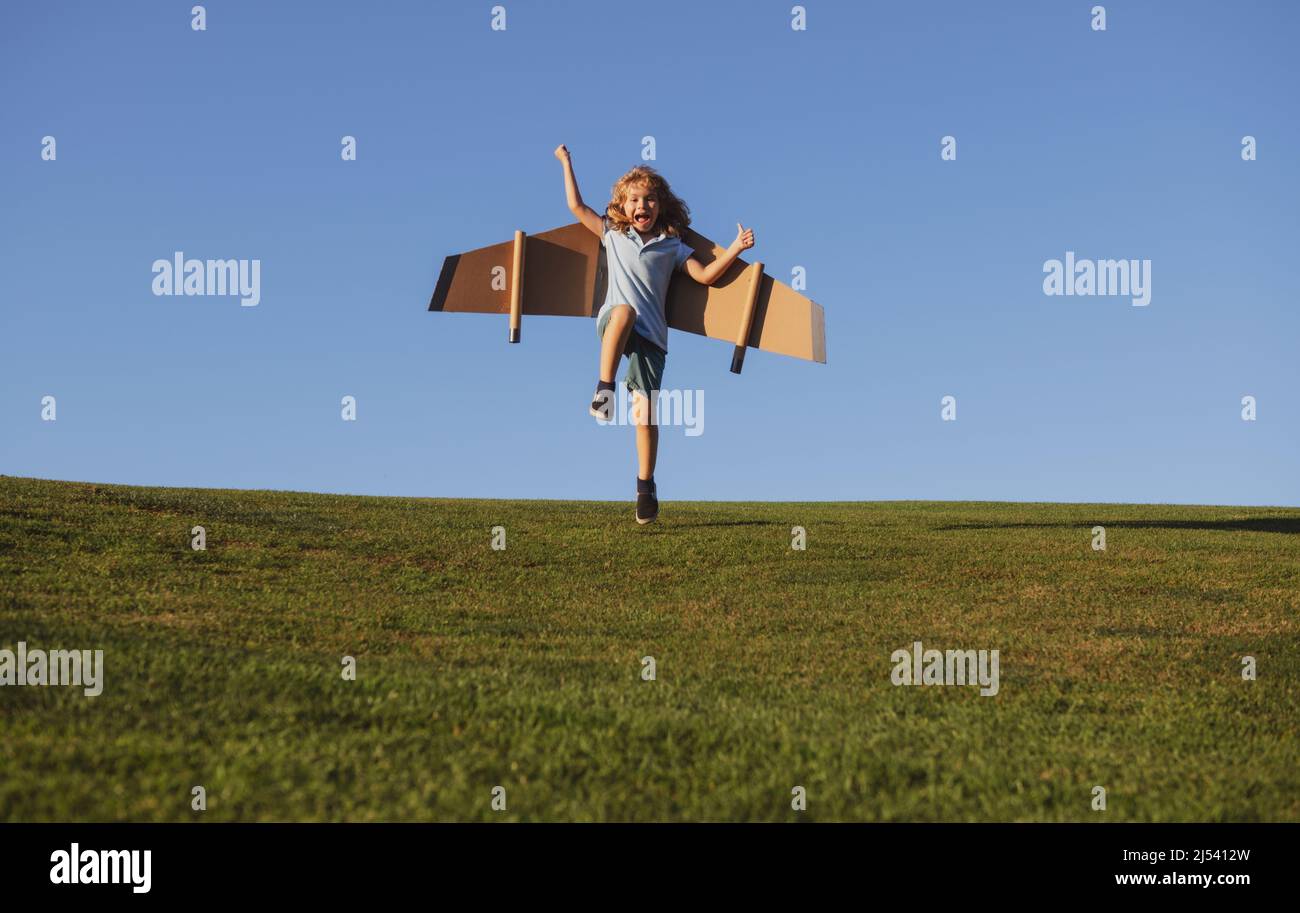 Child jumping and running in park, imagination dream to be pilot ...