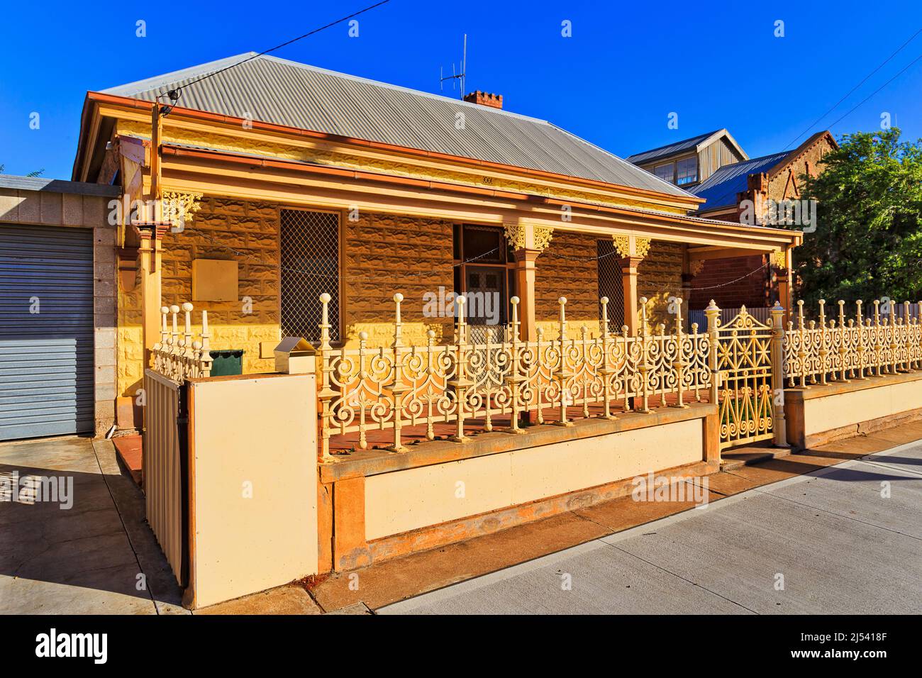 Stone hit resistant house on a downtown street in Broken Hill mining city of Australian outback in arid climate. Stock Photo