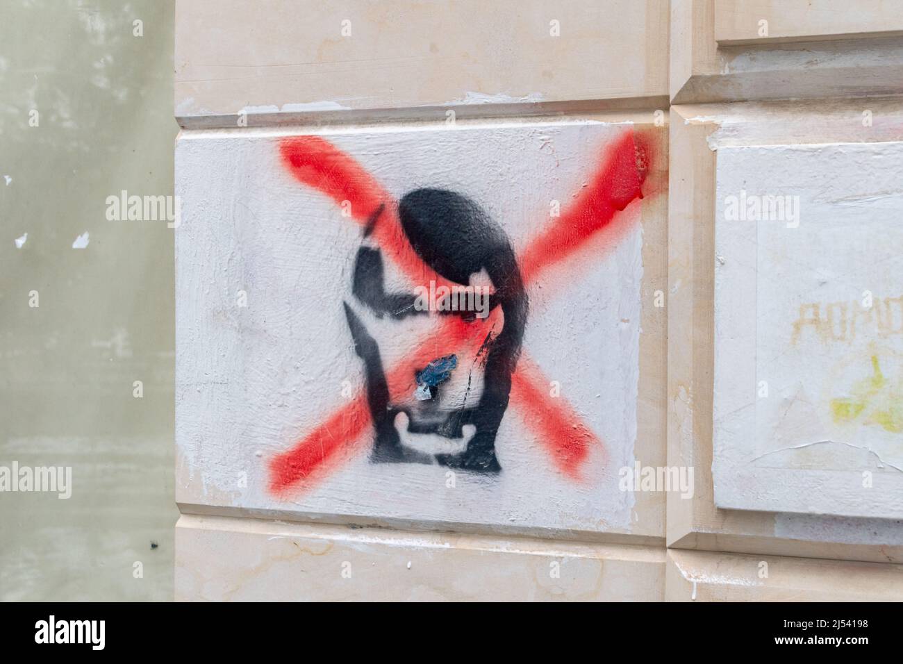 Kutaisi, Georgia - March 17, 2022: Anti Putin graffiti on the wall. Graffiti as symbol of support Ukraine during Russia and Ukraine war. Stock Photo