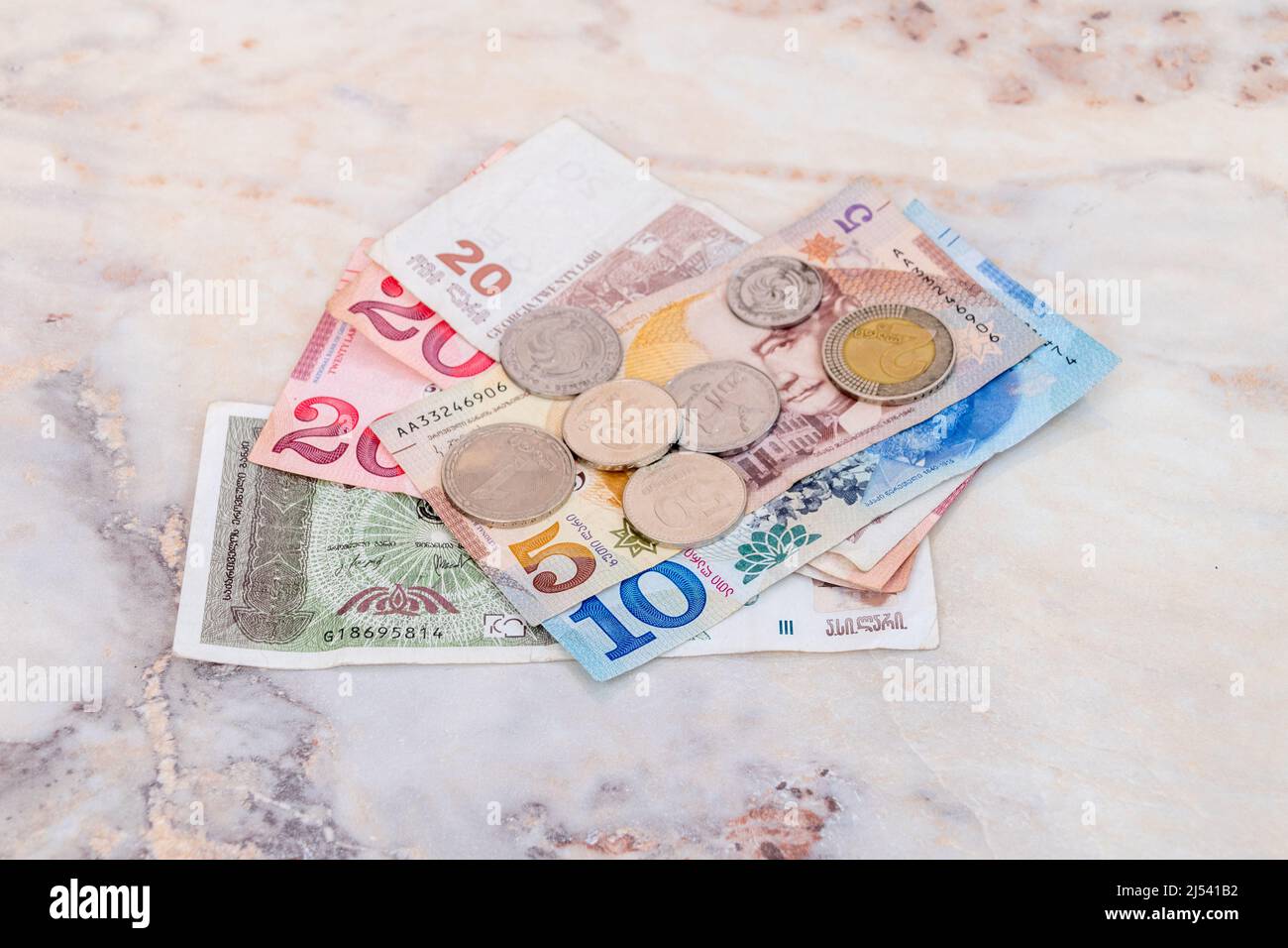 Georgian lari (GEL) banknotes and coins on table. Stock Photo
