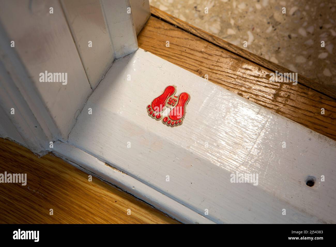 The swastika on a threshold means prosperity. Stock Photo