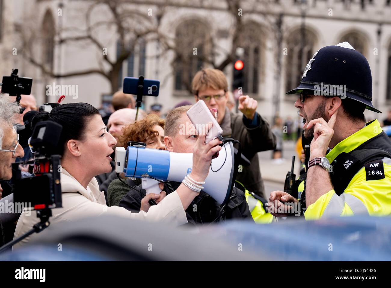 As Prime Minister Boris Johnson was due to apologise to parliament about his fixed-penalty fine for being present at a party during his own Covid pandemic restrictions, anti-vaxx freedom of speech protesters block the gates of parliament during an altercation with Tory MP Bob Blackman, on 19th April 2022, in London, England. The Met police continue to investigate Johnson and his staff as news of more lockdown party fines are expected to be revealed by police. Stock Photo