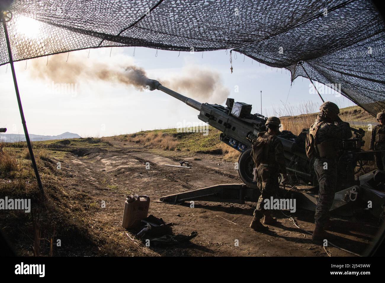 U.S. Marines with 3d Battalion, 12th Marines, 3d Marine Division, fire an M777 towed 155 mm howitzer during Artillery Relocation Training Program 22.1 at the Japan Ground Self-Defense Force Hijudai Training Area, Japan, April 16, 2022. ARTP is an exercise which contributes to the defense of Japan and the U.S.-Japan Alliance as the cornerstone of peace and security in the Indo-Pacific region. The skills developed at ARTP increase the lethality and proficiency of the only permanently forward-deployed artillery unit in the Marine Corps, enabling them to provide precision indirect fires. (U.S. Mar Stock Photo