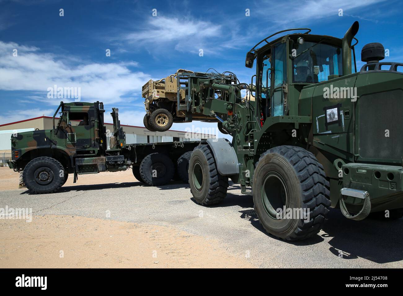 U.S. Marines load a utility task vehicle onto a medium tactical vehicle ...