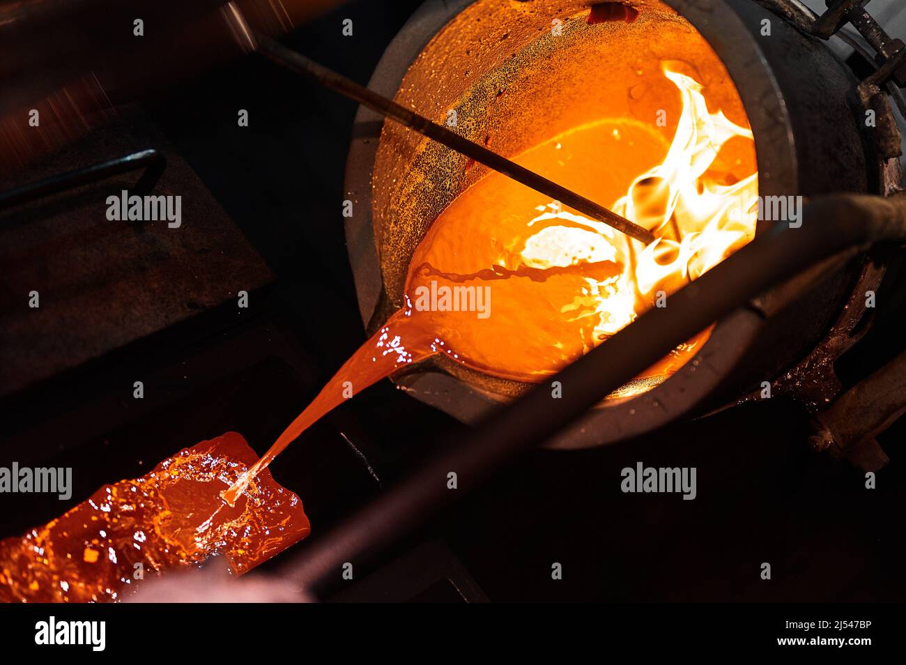 Pouring liquid silver into casting form with metal tool Stock Photo Alamy