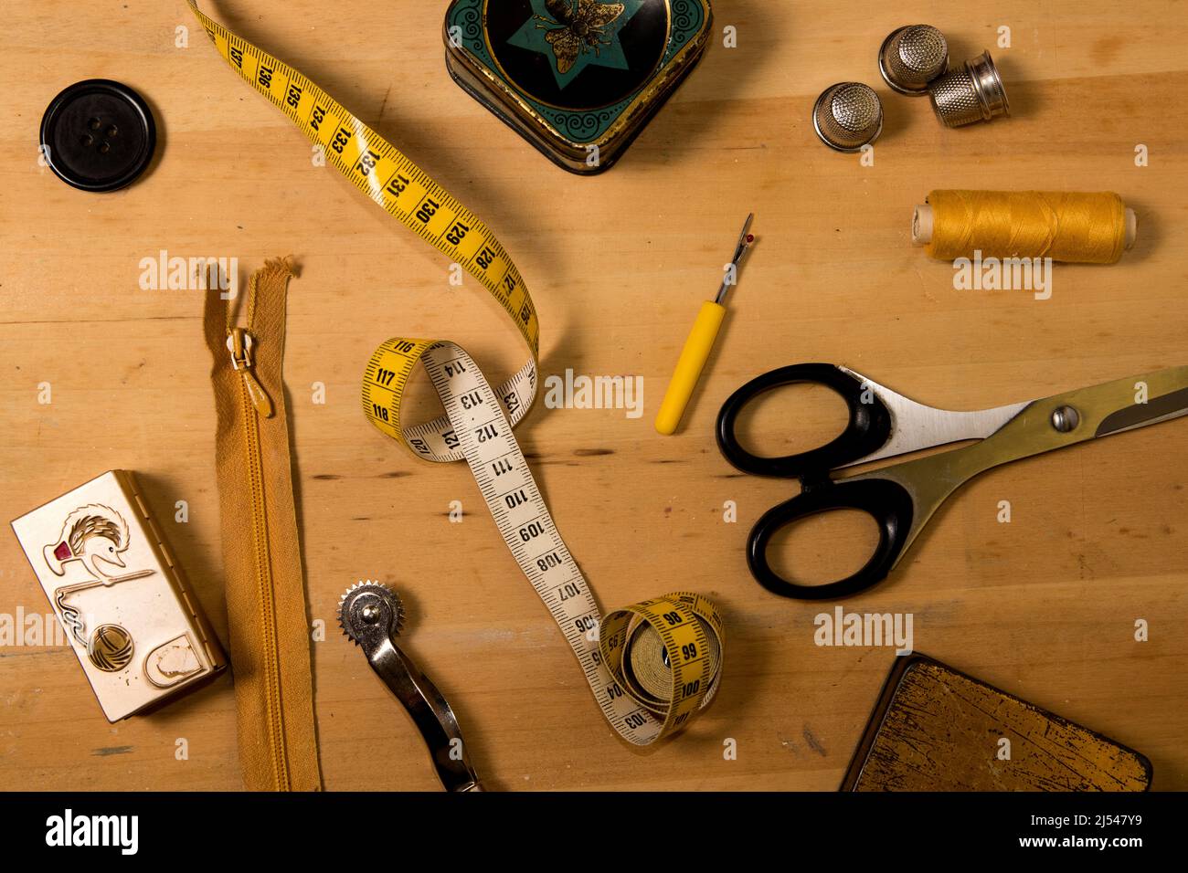 Sewing accessories on wooden board Stock Photo