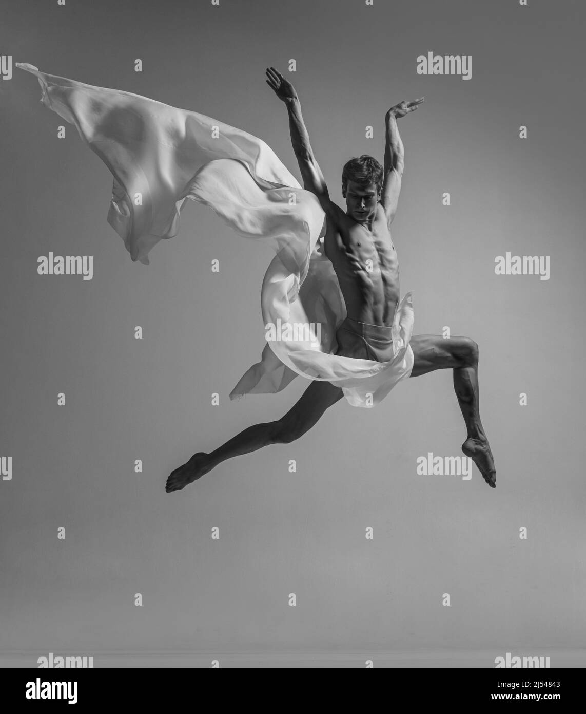 Desire. Black and white portrait of graceful muscled male ballet dancer