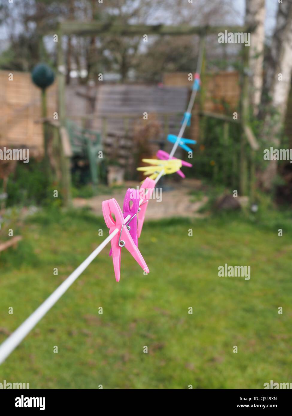 Close-up of some colourful pegs on a washing line shown in shallow focus Stock Photo