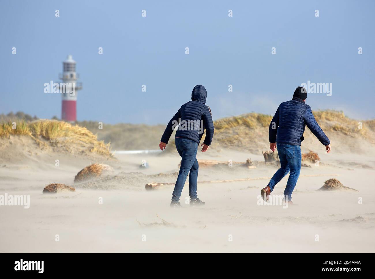 walkers in the storm on the sandy beach, Hurricane Eunice, Zeynep, 02/19/2022, Belgium, West Flanders, Nieuwpoort Stock Photo